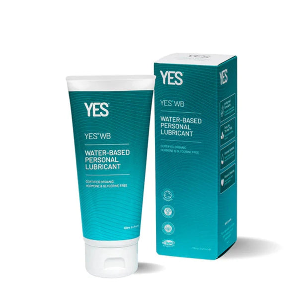 Image of a product called "YES® WB Water-Based Lubricant" by YES®. This organic, pH balanced lubricant is dermatologically approved, hormone and glycerine-free, and certified organic. The white tube with a green label stands next to its matching green box, offering long-lasting hydration.