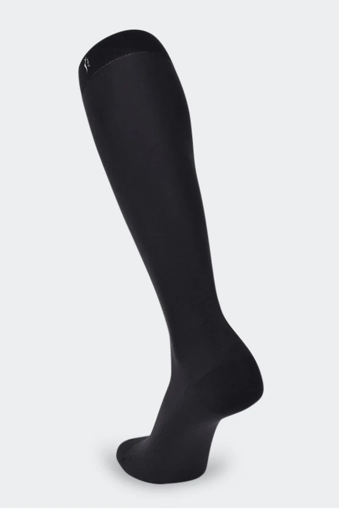 Black knee high compression stockings for improved blood circulation and reduced leg fatigue, ideal for use during pregnancy and post partum, for athletes, travelers, and individuals with varicose veins.