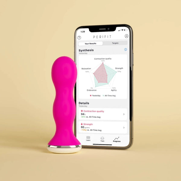 The Perifit Kegel Exerciser – Smart Pelvic Floor Trainer by Perifit stands upright beside a smartphone showing the Perifit app with progress graphs, designed to strengthen the pelvic floor and help manage bladder leakage.