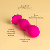 The Perifit Kegel Exerciser – Smart Pelvic Floor Trainer by Perifit is a pink, medical grade silicone device with superficial and deep pelvic floor sensors plus a low energy Bluetooth antenna, set against a beige background.