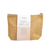 An Antenatal Colostrum Collection Kit by The Breastfeeding Tea Co, neatly packaged in a tan woven pouch with a zipper, is labeled 