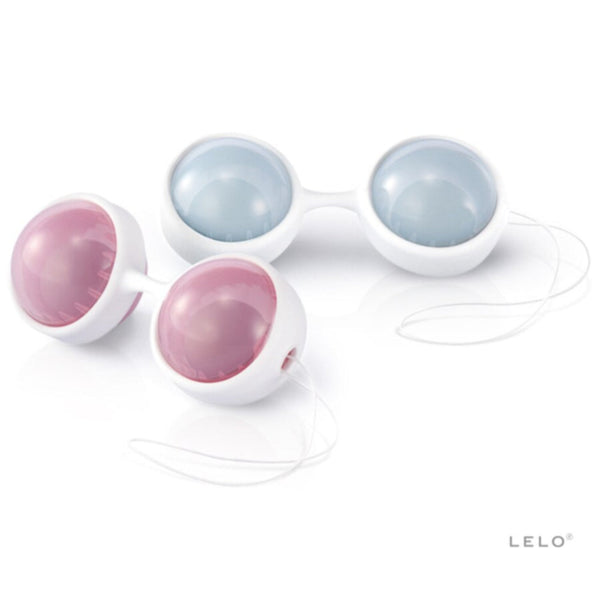 Two sets of round, white LELO Luna Beads Mini kegel exercise balls with light blue and pink inner spheres, connected by a white cord, are displayed on a white surface. The LELO logo appears at the bottom right. Ideal for pelvic floor strengthening.