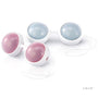 Two sets of round, white LELO Luna Beads Mini kegel exercise balls with light blue and pink inner spheres, connected by a white cord, are displayed on a white surface. The LELO logo appears at the bottom right. Ideal for pelvic floor strengthening.