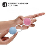 A hand holds a pair of connected LELO Luna Beads Classic kegel exercisers, one blue and one pink, with the text 