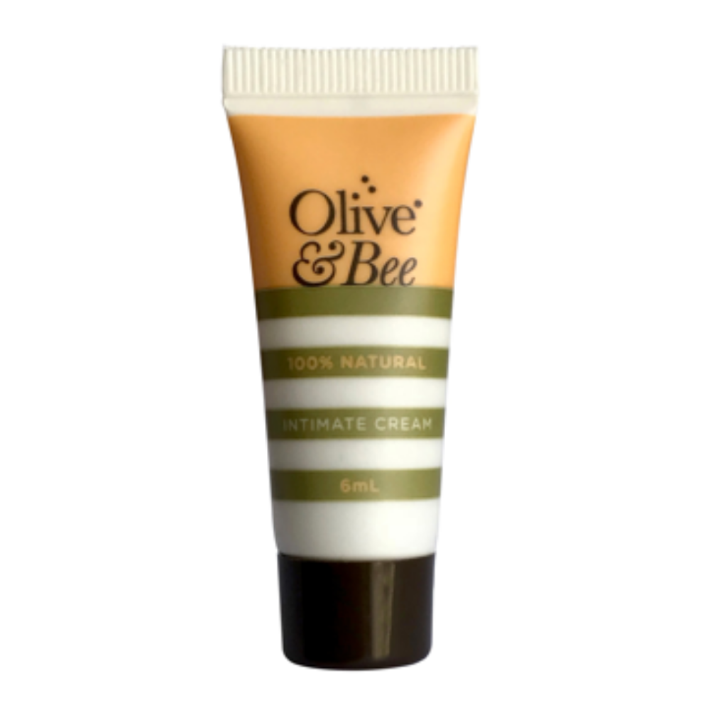 A tube labeled "YES® Olive & Bee Intimate Cream, 6mL" with an orange and white color scheme and a black cap, designed for sensitive skin hydration using a chemical-free moisturizer.