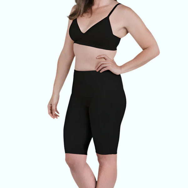 Woman wearing black SRC Restore knee-length compression shorts, front view