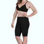 Woman wearing black SRC Restore knee-length compression shorts, front view