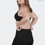 Woman wearing black SRC Restore Mini compression shorts, front view