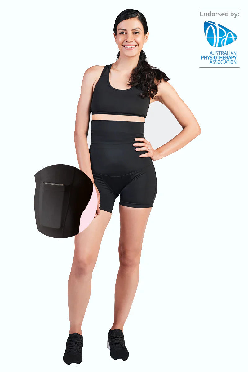 Woman wearing black SRC C-Section Recovery Mini compression shorts, front view