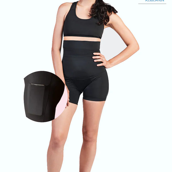 Woman wearing black SRC C-Section Recovery Mini compression shorts, front view
