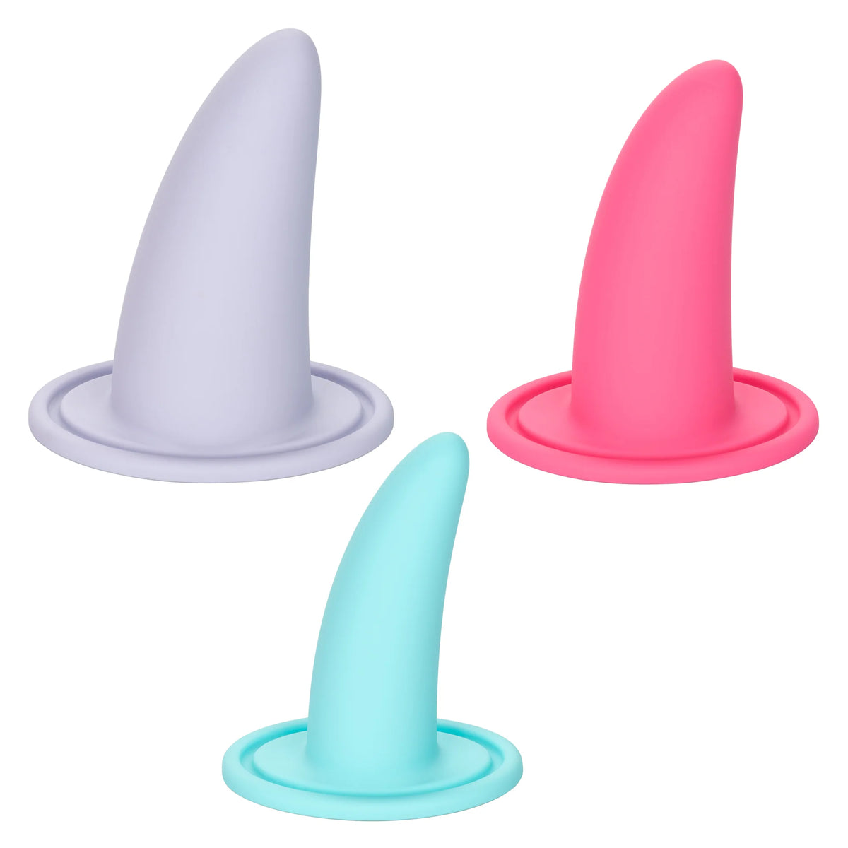 The image displays the She-ology™ 3-piece Wearable Vaginal Dilator Set by Calexotics. The set includes three dilators made from body-safe silicone, shown in light gray, pink, and light blue colors. Each dilator features an upright design with a circular base for easy use.