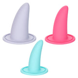 The image displays the She-ology™ 3-piece Wearable Vaginal Dilator Set by Calexotics. The set includes three dilators made from body-safe silicone, shown in light gray, pink, and light blue colors. Each dilator features an upright design with a circular base for easy use.