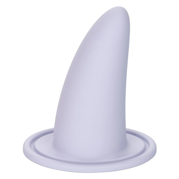 The She-ology™ 3-piece Wearable Vaginal Dilator Set by Calexotics features a smooth, conical white dilator rising from a circular base. The sleek design, made from body-safe silicone with a soft matte finish, resembles a fin or horn and is ideal for use as part of the wearable set.
