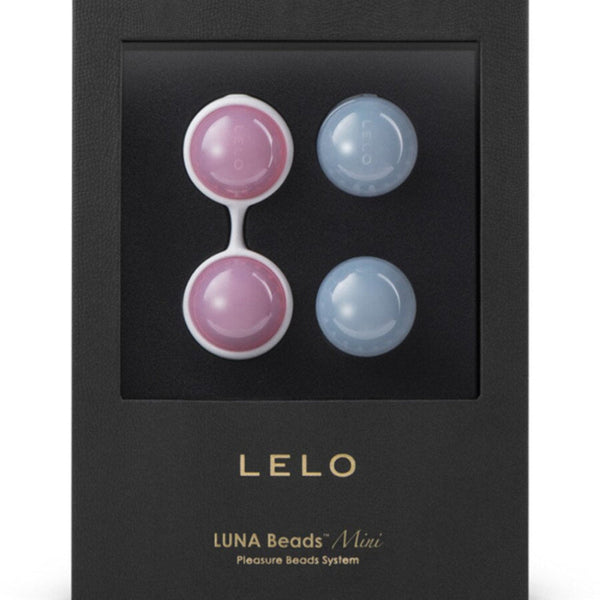 A black box with a clear window displays LELO Luna Beads Mini by LELO—Kegel exercisers with two pink beads in a white holder and two blue beads, ideal for pelvic floor strengthening. Gold text reads "LELO LUNA Beads Mini Pleasure Beads System.