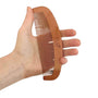 A hand holds the Bubba Bump Labour and Birth Comb, a curved wooden tool with evenly spaced teeth and an acupressure design. Its side features a logo, providing a soothing experience akin to drug-free pain relief.