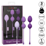 The Calexotics Kegel Weights - 3-Piece Set packaging contains three purple kegel exercisers made from body-safe silicone, designed to strengthen pelvic floor muscles. Each piece features a convenient retrieval cord and comes with a 1-year warranty for peace of mind.