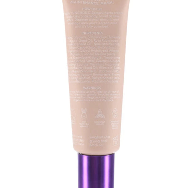 An image of the C-Section Mama Cream by Yung Bod, featuring a beige cosmetic tube with a purple cap. The front of the tube is covered in white text detailing product information, natural ingredients, and usage instructions, highlighting its effectiveness as a scar softening cream.