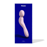 The Dame Com - External Wand Vibrator by Dame is beautifully presented against a blue background, featuring a light pink wand design that offers rumbly vibrations and a flexible neck for enhanced comfort and satisfaction.