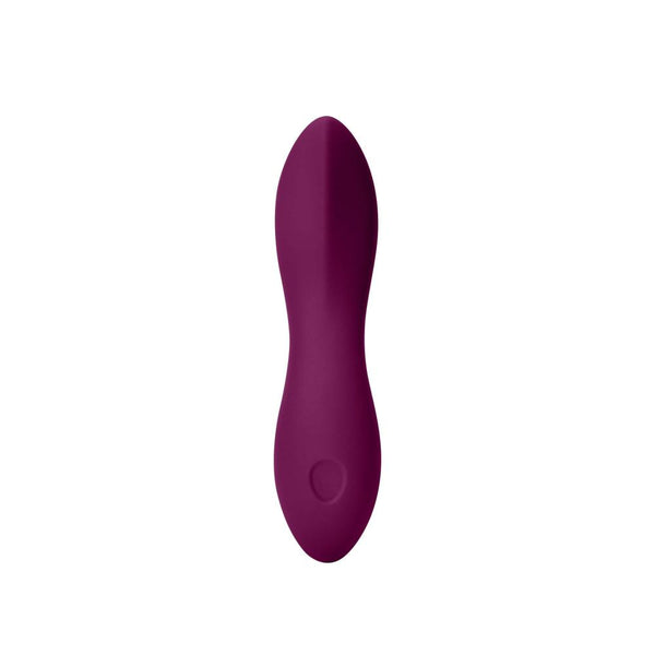 The Dame Dip 2.0 - Basic Vibrator by Dame is a purple, oval-shaped personal massager crafted from medical-grade silicone. It features a sleek design with a textured surface and has a small circular button at one end, making it ideal for clitoral stimulation. The vibrator is set against a plain white background.