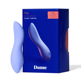 A blue vibrator made from medical-grade silicone is positioned upright beside its box. The deep blue packaging features 