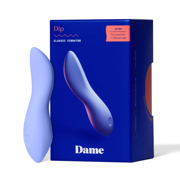 A blue vibrator made from medical-grade silicone is positioned upright beside its box. The deep blue packaging features "Dame Dip 2.0 - Basic Vibrator" in white, emphasizing its design for both external clitoral stimulation and internal use.
