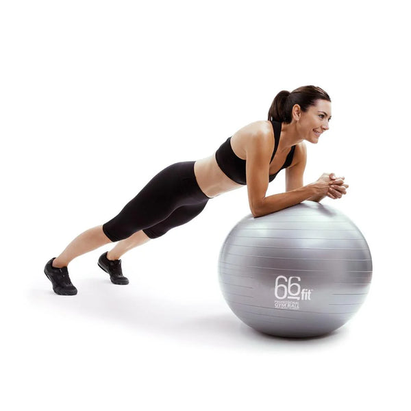 A woman doing a core exercise on an exercise ball, resting on her elbows and engaging her abdominal muscles.