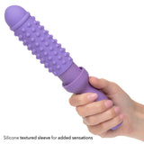 A hand holds the Dr. Laura Berman® Rechargeable Vibrating Vaginal Dilator Set by Calexotics, featuring a removable silicone textured sleeve with raised bumps for enhanced sensations and pelvic wellness.