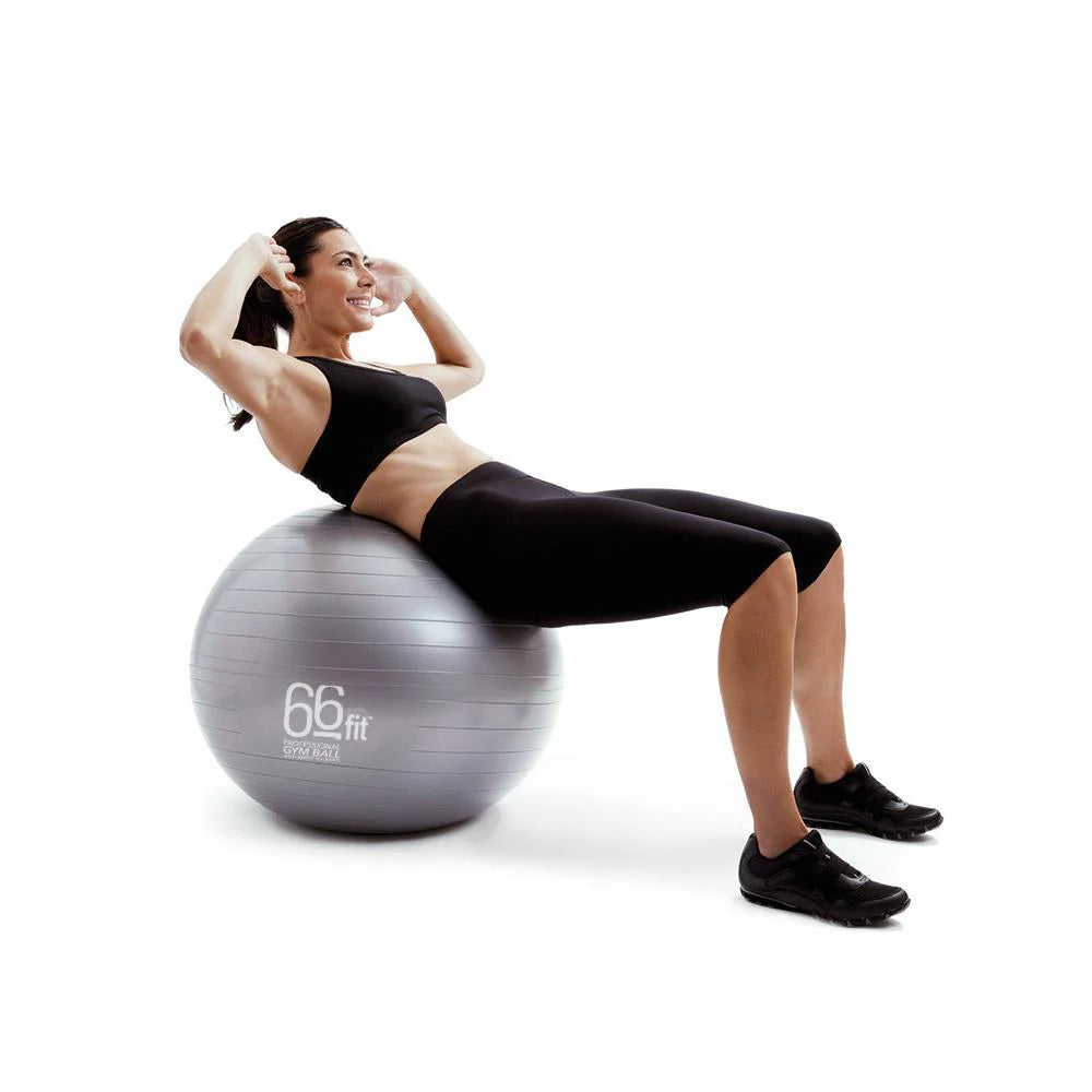 A woman performing a sit-up on a gym ball, engaging her core muscles and balancing on the ball.