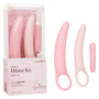 The Calexotics Inspire Vibrating Dilator Kit 3-Piece Set includes two pink silicone curved dilators with finger loops and a bullet vibrator, ideal for pelvic floor therapy. Shown in and out of box highlighting gentle vibration features.