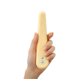 A hand holds the Iroha Mikazuki, a gentle slim vibrator for beginners by Iroha, featuring a beige, elongated oval design with two metal buttons and crafted from body-safe silicone, shown against a white background.