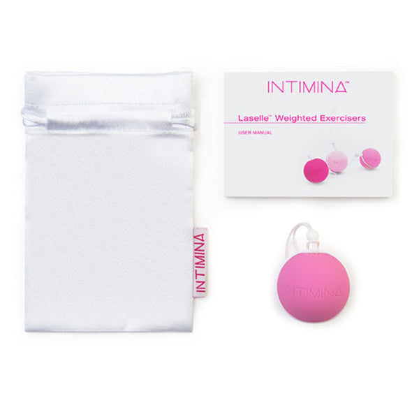A white pouch, user manual, and pink round Intimina Laselle Kegel Exerciser with a white string on a white background—ideal for strengthening pelvic floor muscles with Intimina's Laselle Kegel Exercisers.