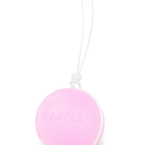 The Intimina Laselle Kegel Exercisers are small, round, pink silicone balls with "INTIMINA" embossed and a white string loop—an ideal minimalistic choice for strengthening pelvic floor muscles.