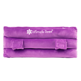 The Intimate Rose Post-Surgery Seat Belt Pillow in purple is designed for ultimate comfort and post-surgery pain relief. It features soft, plush fabric and adjustable velcro straps, making it an ideal support option as a mastectomy pillow alternative. The fabric proudly displays the brand logo.