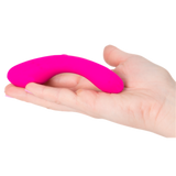 A hand holds The Mini Swan Wand, a small G spot vibrator from Swan, featuring a bright pink color and a smooth silicone texture.