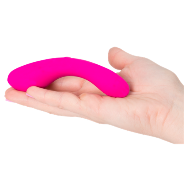 A hand holds The Mini Swan Wand, a small G spot vibrator from Swan, featuring a bright pink color and a smooth silicone texture.