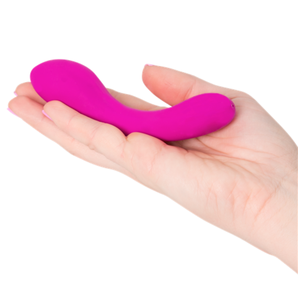 A hand holds a small, curved, pink Mini Swan Wand by Swan with two bulbous ends—an elegant waterproof G-spot vibrator.