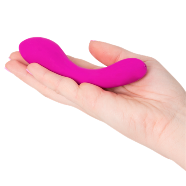 A hand holds a small, curved, pink Mini Swan Wand by Swan with two bulbous ends—an elegant waterproof G-spot vibrator.