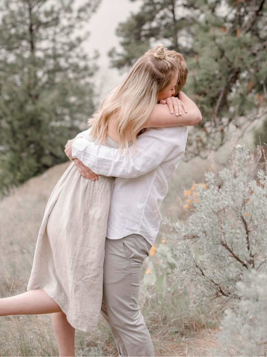 A couple embraces outdoors in soft daylight — relaxed, comfortable intimacy after introducing Ohnut depth-limiting rings into their routine. Lifestyle imagery for the Ohnut Australia review on Blossom Pelvic Health.