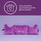 Against a purple background, the Post-Surgery Mastectomy Pillow from Intimate Rose is shown with armrests. In the top left corner, a white gift icon with a heart is accompanied by the text: 