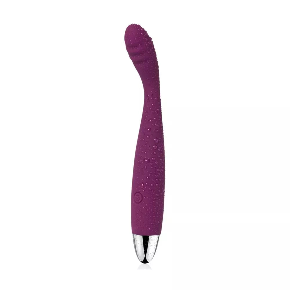 The Svakom Cici – Slim Flexible G-Spot Vibrator by Svakom is a purple silicone vibrator with a curved, textured tip and a silver base, shown with water droplets on its surface against a plain white background.