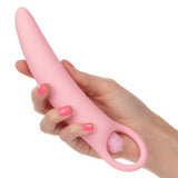 A hand with pink-painted nails holds the Calexotics Inspire Vibrating Dilator Kit 3-Piece Set, featuring a rounded tip and looped handle, ideal for pelvic floor therapy, against a white background.