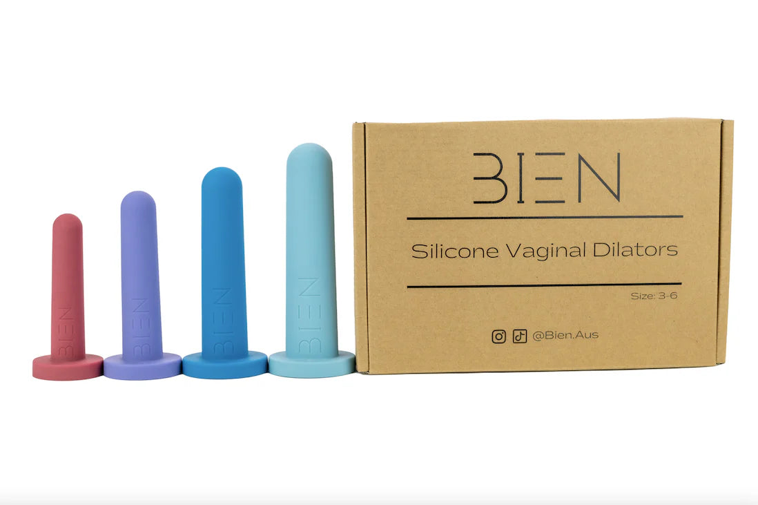 A set of four Bien Silicone Vaginal Dilators from BIEN Australia features medical-grade silicone in graduated sizes, arranged next to a cardboard box labeled "Bien Silicone Vaginal Dilators - Medium Set." The dilators are displayed in shades of pink, purple, blue, and aqua, from smallest to largest.