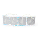 A row of four square AllCare Electrodes with wires, featuring a mesh-like texture, partially wrapped in white and blue backing for secure therapy sessions.