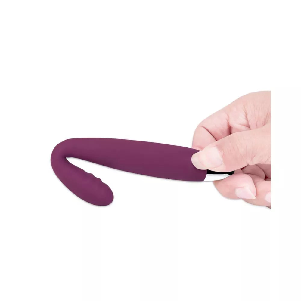 A hand holds the Svakom Cici – a slim, flexible G-Spot vibrator by Svakom, featuring a purple silicone body and curved, textured tip for pelvic pain relief, shown against a plain white background.