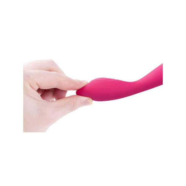 A hand bends the flexible, pink silicone shaft of the Svakom Iris Slim Semi-Flexible G-Spot Vibrator against a white background—ideal for those seeking targeted pelvic pain relief.