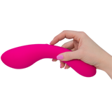 A hand with pale skin and pink-painted nails holds The Swan Wand, an ergonomically shaped, phthalate-free vibrator from Swan, against a white background.