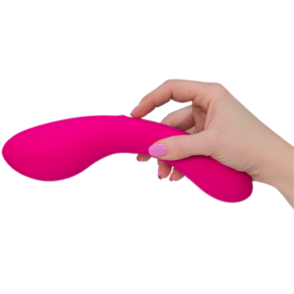 A hand with pale skin and pink-painted nails holds The Swan Wand, an ergonomically shaped, phthalate-free vibrator from Swan, against a white background.