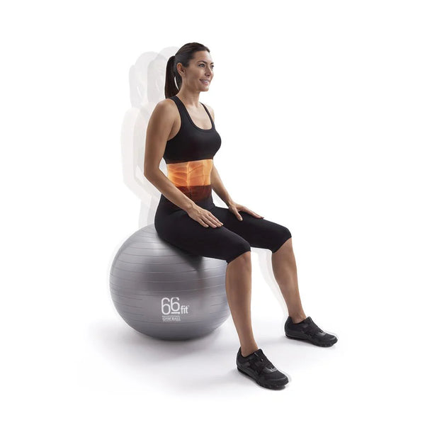 A woman sitting on a gym ball, engaging her core muscles and maintaining balance