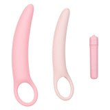 The Calexotics Inspire Vibrating Vaginal Dilator Kit 3-Piece Set features two pink silicone dilators with ring-shaped handles and a matching bullet vibrator, perfect for pelvic floor therapy and comfort.