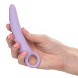 A hand with pink nail polish holds a slim, light purple Calexotics Dr. Laura Berman® Alena™ Silicone Vaginal Dilator from the small set, designed for pelvic floor rehabilitation, against a white background.
